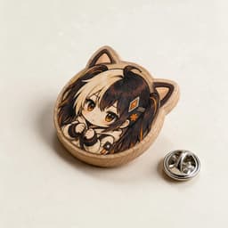 Cat-ear shaped beechwood badge photographed at a 45-degree angle to show wood thickness and grain, with a butterfly pin clasp beside it