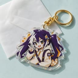 Custom rainbow acrylic keychain photographed on pale aqua paper