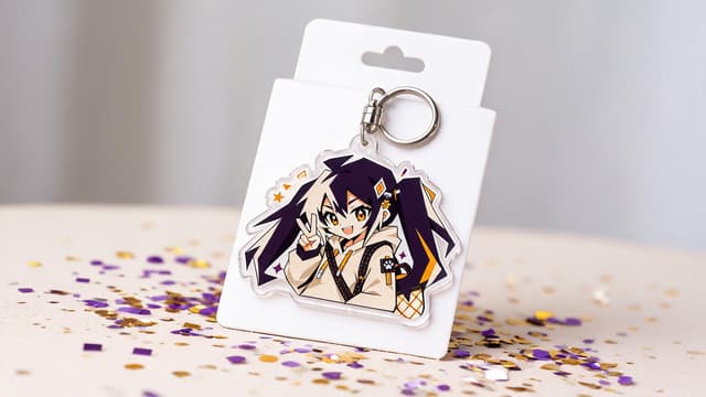 Custom die-cut clear acrylic keychain with printed artwork displayed on its backing card