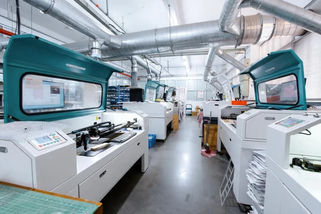 Row of laser cutting machines on our acrylic production floor