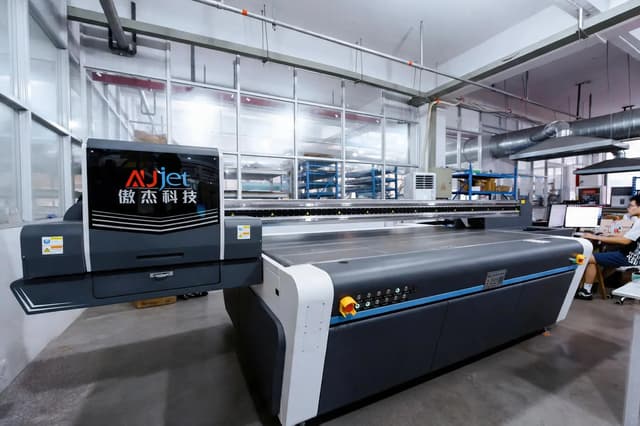 Flatbed UV printer on our production floor for direct-to-sheet printing