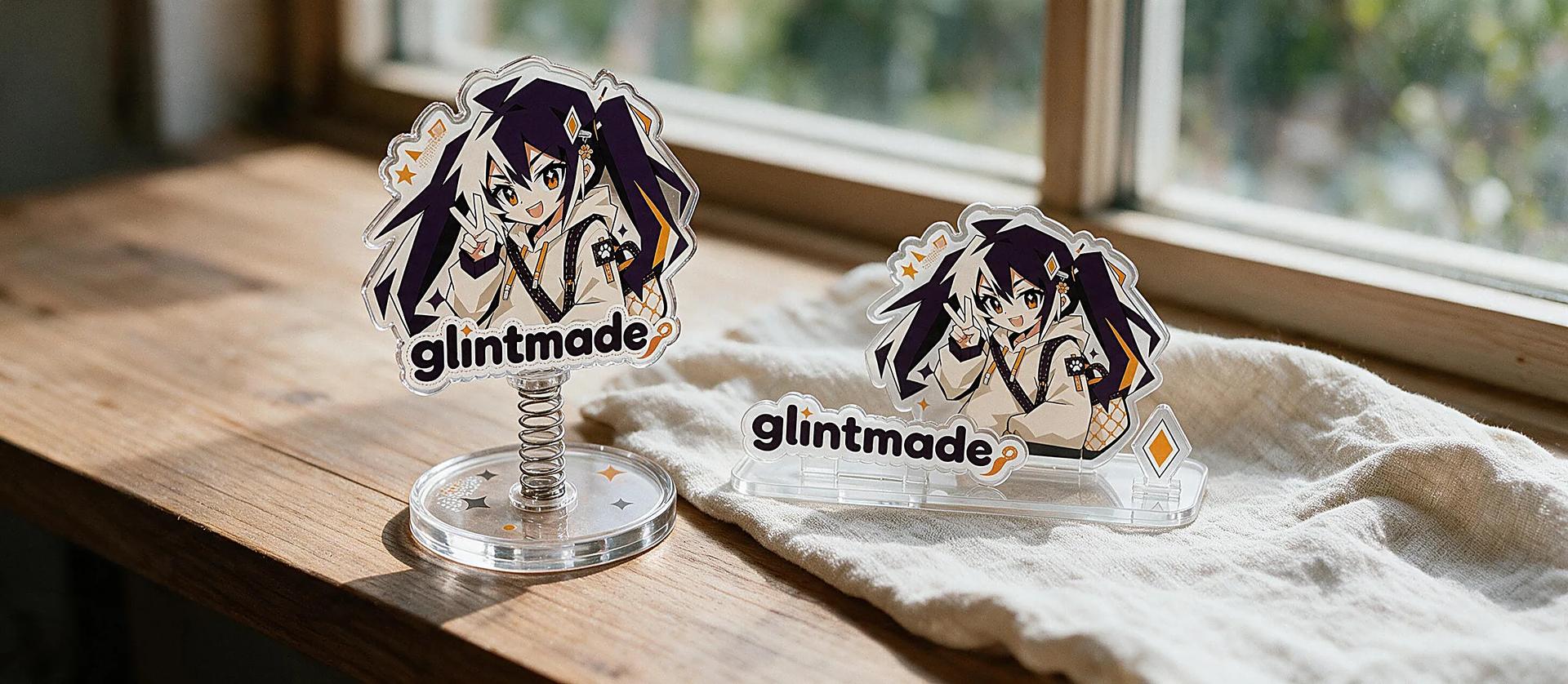 Custom acrylic standees with character art standing on clear bases beside a thick acrylic block